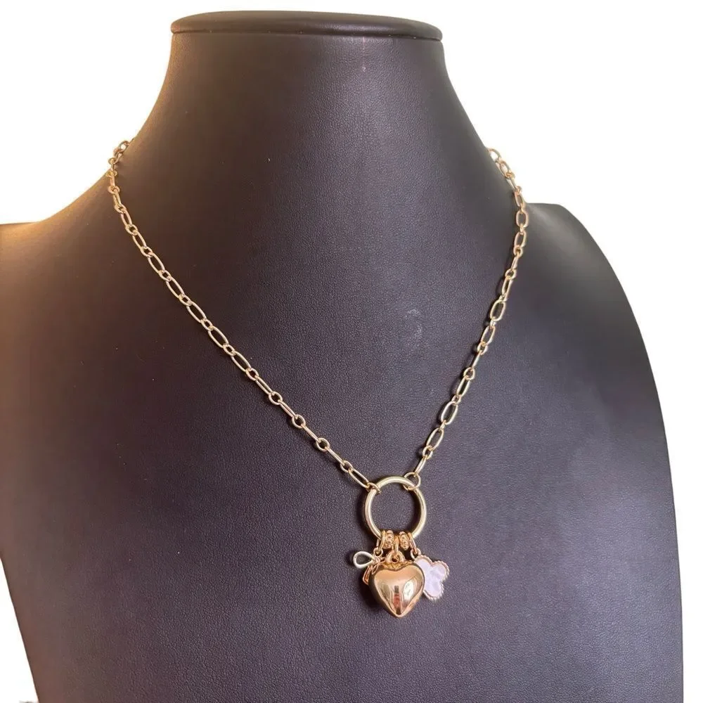 Gold Tone Multi-Charm Necklace w/ Puffy Heart, White Clocer & Gold Bow.